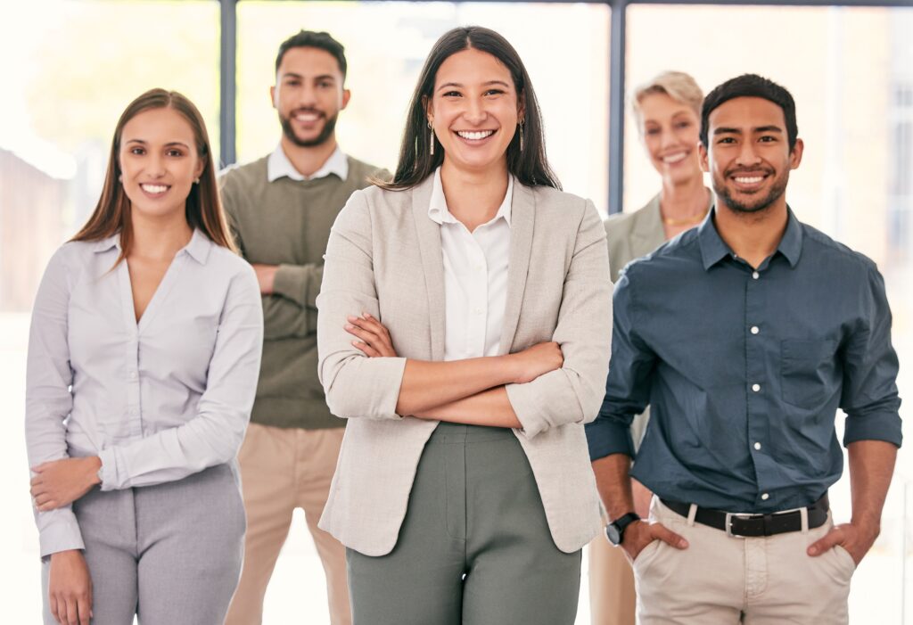 A group of sales professionals with different job roles smiling.