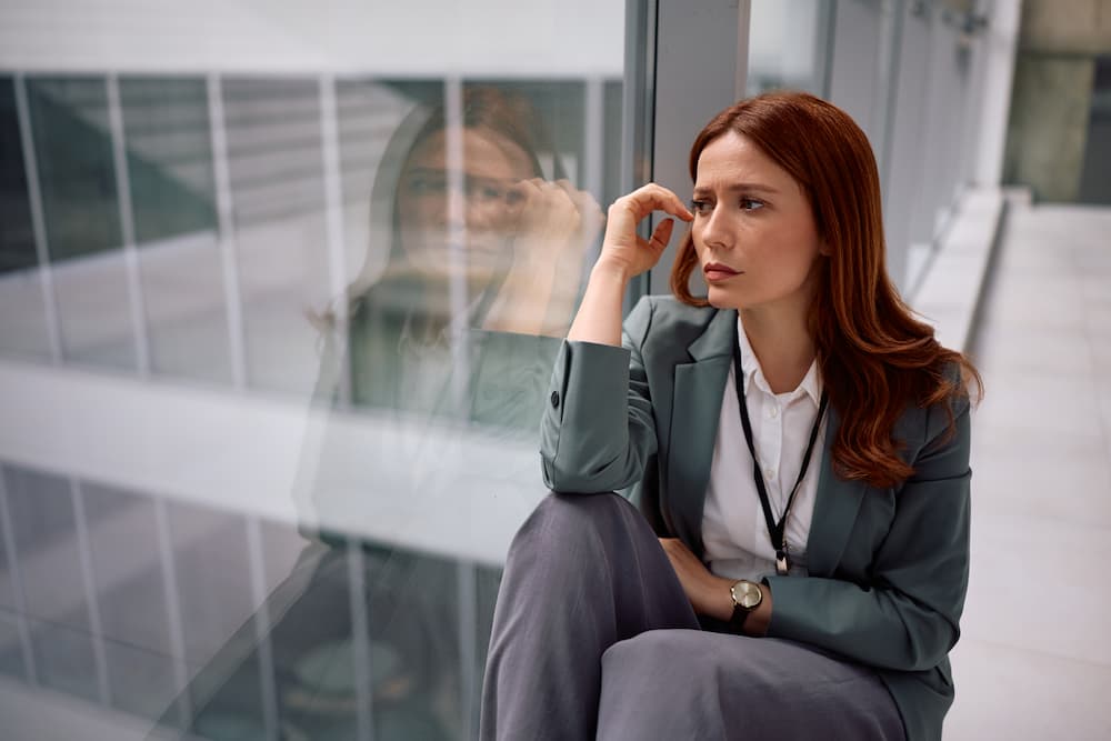 A female employee thinking about her career stability.